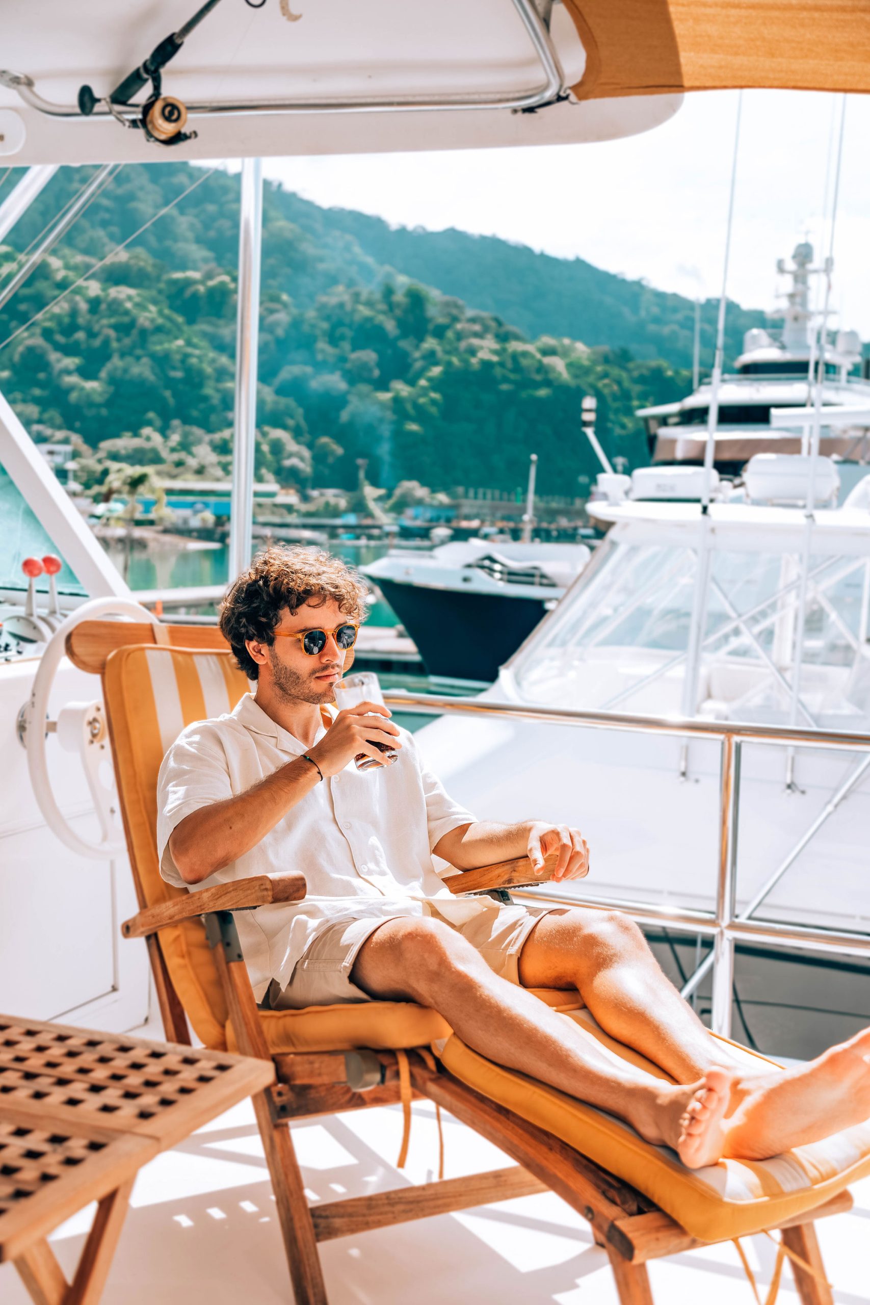 Boat owner relaxing at Marina Bahía Golfito with yachts in the background