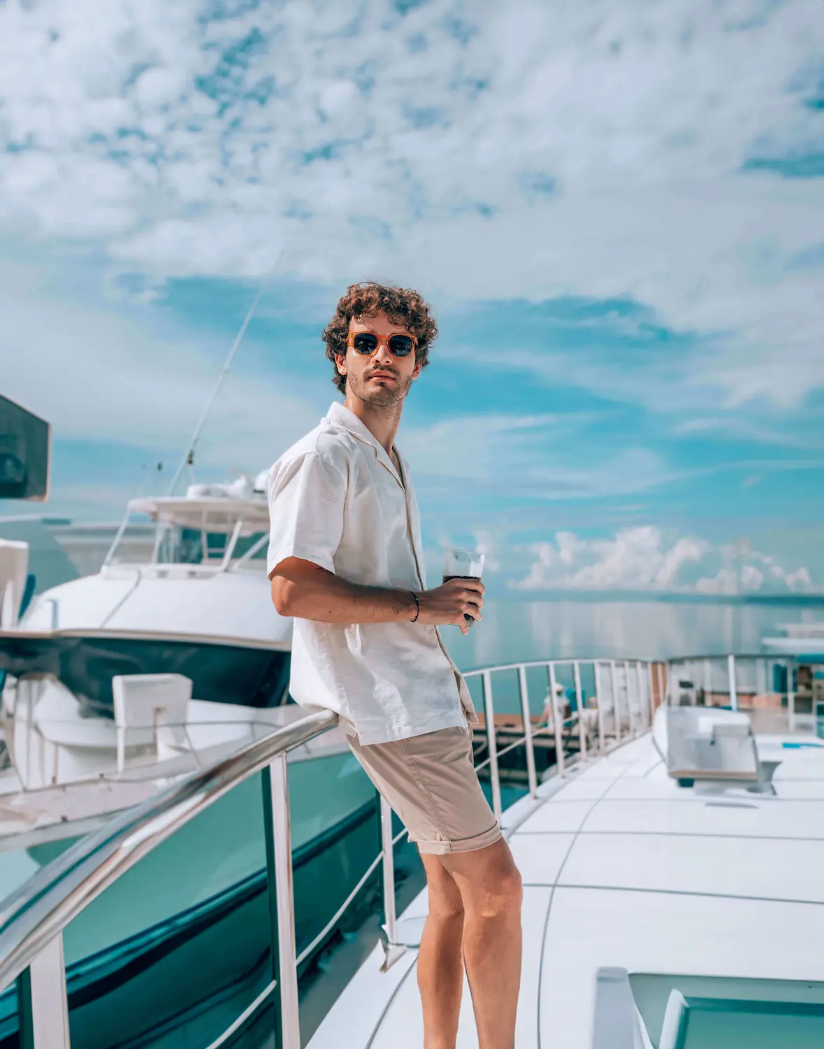 Man aboard a yacht at the marina looking out to sea