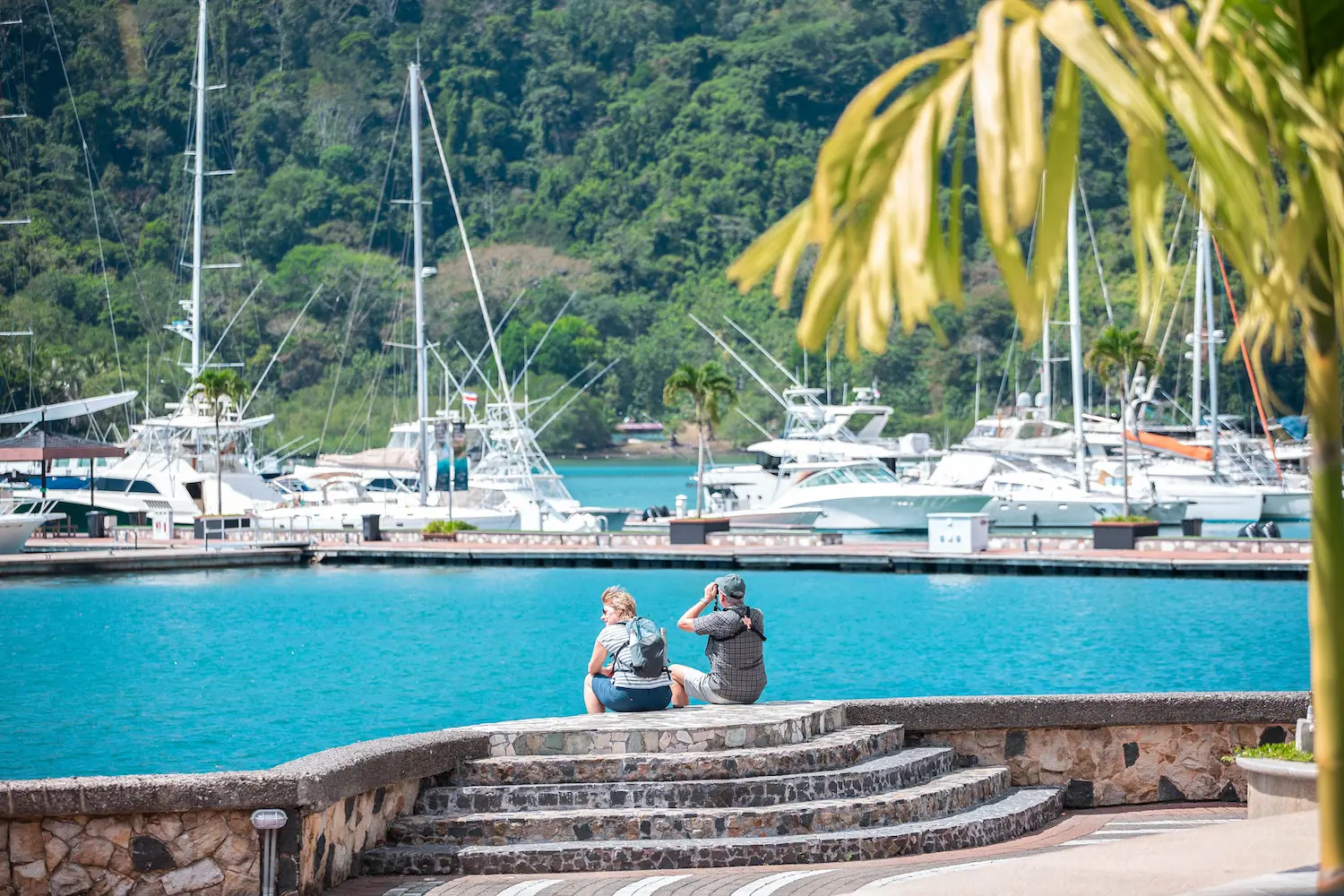 Boats moored at Marina Bahía Golfito with jungle backdrop