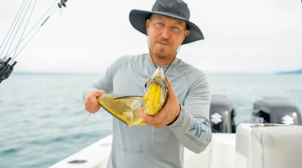 Angler holding a fresh yellowfin tuna caught sport fishing in Costa Rica's Golfo Dulce near Golfito