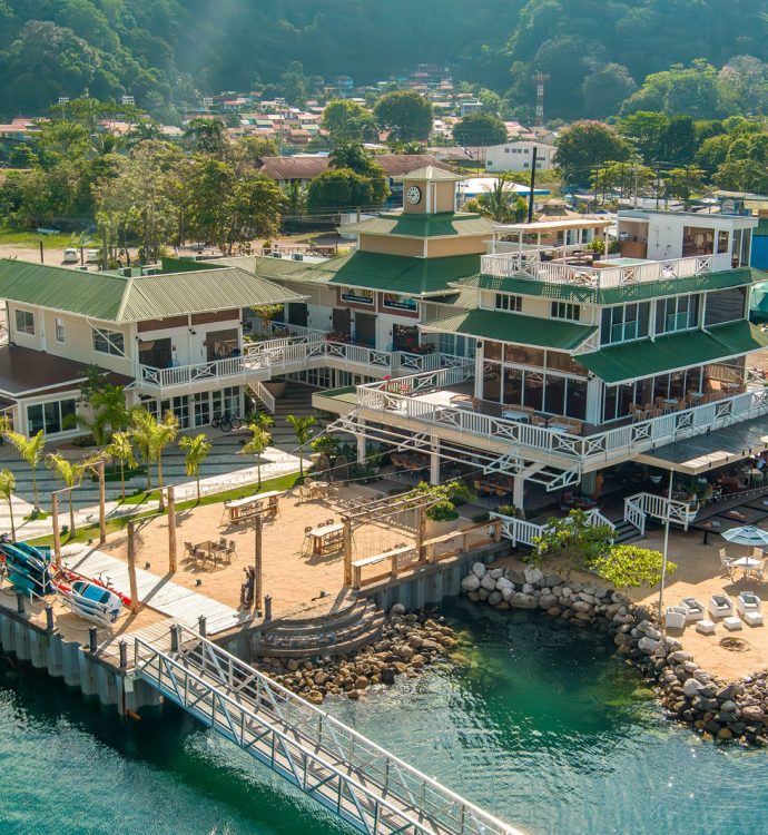 Aerial view of Marina Bahía Golfito waterfront with marina buildings and docks, Golfito Costa Rica