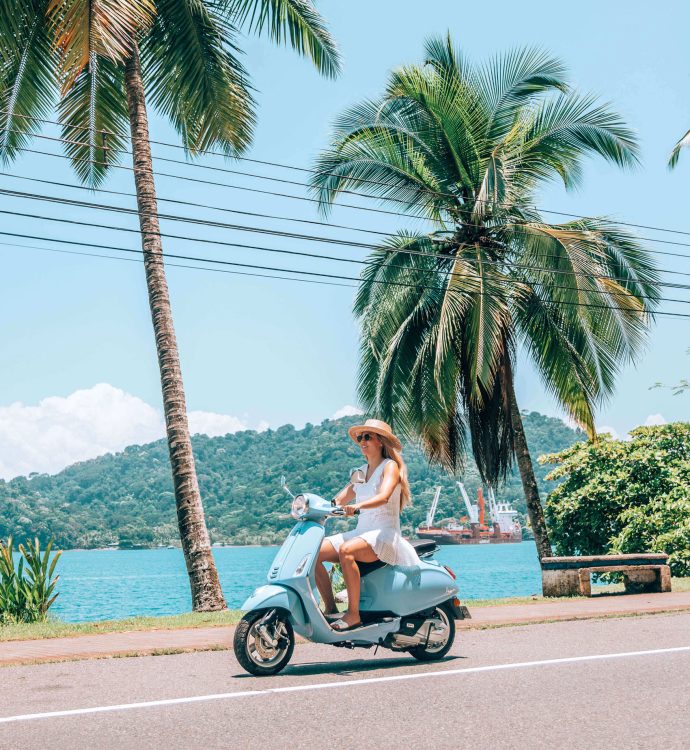 Woman on a Vespa scooter along the Golfito waterfront, Marina Bahía Golfito