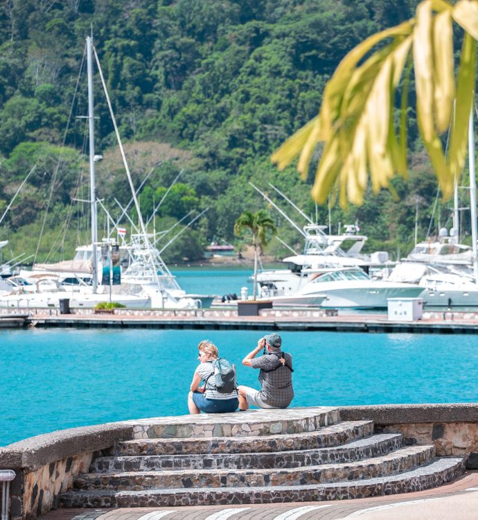 Couple at Marina Bahía Golfito overlooking yacht slips and Golfo Dulce, Costa Rica